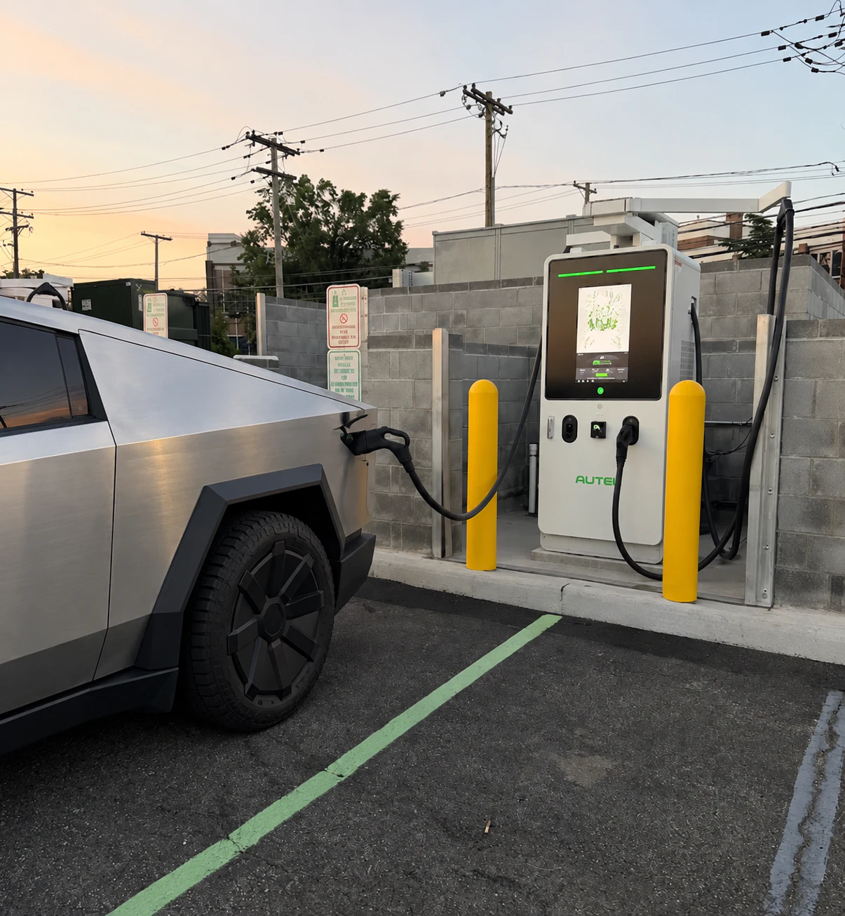 Tesla Cybertruck connected to an Autel charging station at dusk